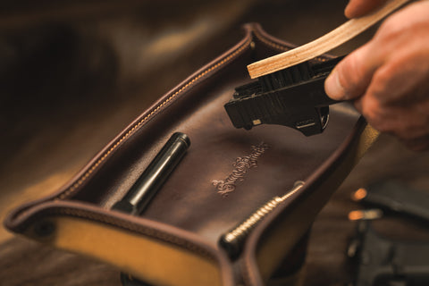 Cleaning firearms in leather parts tray